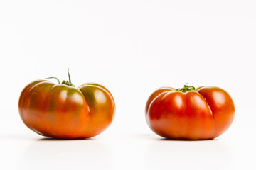 Two tomatoes on white background