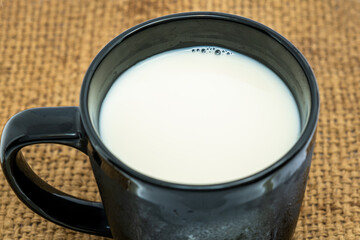Black Glass of milk on white background. Healthy beverage concept. Top view