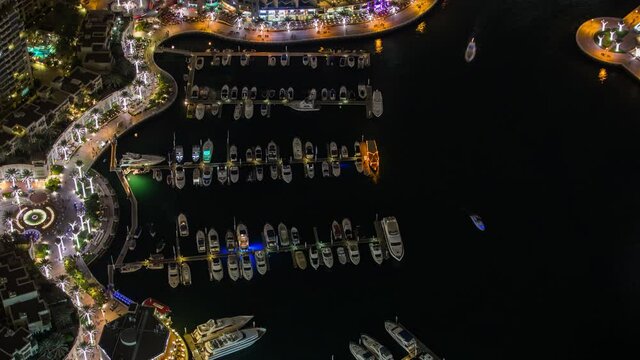 Beautiful moving timelapse in Dubai UAE from princess tower showing traffic at night of the marina port at slow shutter speed