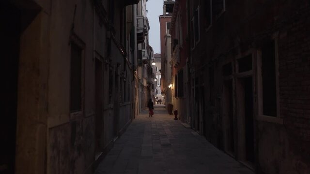 Woman walking alone in an empty alley (slow motion 120fps)
