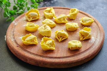 tortellini pasta stuffed ravioli Menu concept serving size. food background top view copy space