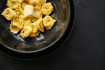 tortellini pasta stuffed ravioli Menu concept serving size. food background top view copy space