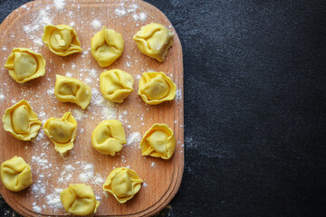 tortellini pasta stuffed ravioli Menu concept serving size. food background top view copy space