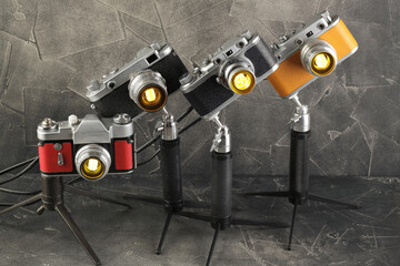 A vintage lamps made by me from an old film cameras on a gray cement background.