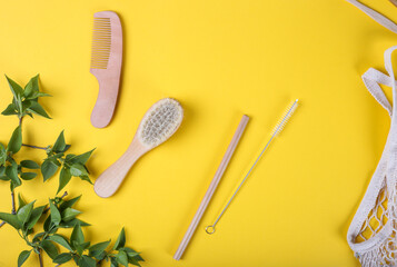 Set of Eco friendly bamboo combs on yellow backing. ECO brush. Sustainable lifestyle. Plastic free concept. Top view, flat lay, mockup