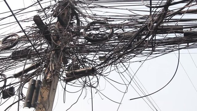 An unthinkable unacceptable tangle of electrical wires on a pole is a common sight in many countries of South-East Asia.

