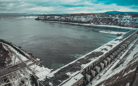 Bratskaya hydroelectric power station in winter in the snow on the Angara river