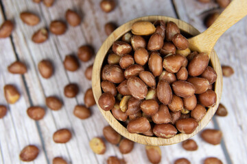 Peanuts peeled in a wooden bowl (Choose the focus, the beans that are in a wooden bowl) Cereal nourishing nourishment Food for health lovers