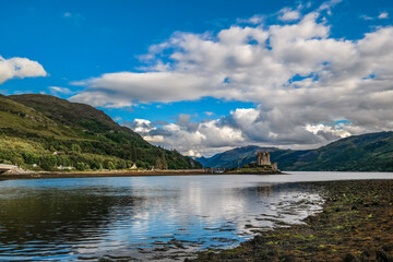Fototapeta premium Eilean Donan Castle on water at summer from far