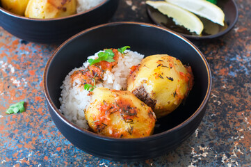 Baked potato stuffed with mince meat and rice with salad.