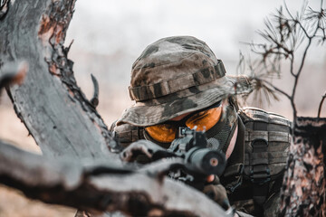 A man in a military uniform is aiming a weapon in the forest. Mobilization 2022