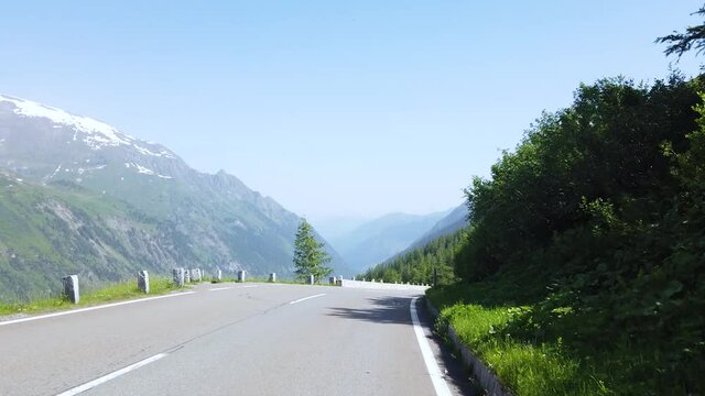View from fast car driving on Grossglockner High Alpine Road by high mountains in Austria