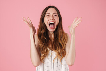 Image of excited beautiful woman screaming with throwing up hands