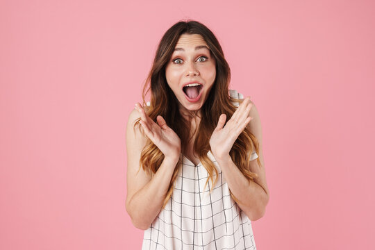 Image of delighted beautiful woman expressing surprise at camera