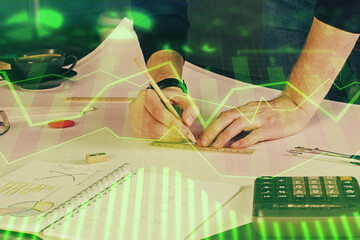 Double exposure of man writing on paper with forex graph.