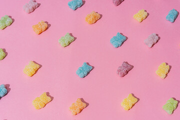 multi-colored jelly bears on a gently pink background
