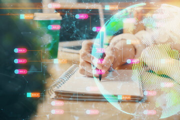 Double exposure of hands making notes with world map hologram and data theme icons. Concept of global computer data.