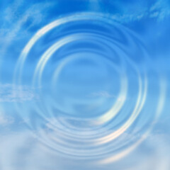 Water ripple reflecting cloudy blue sky