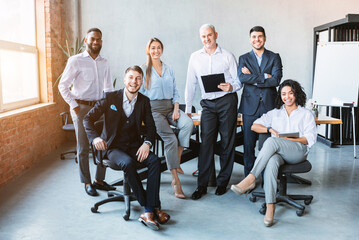 Successful Business Team Posing Smiling To Camera In Modern Office