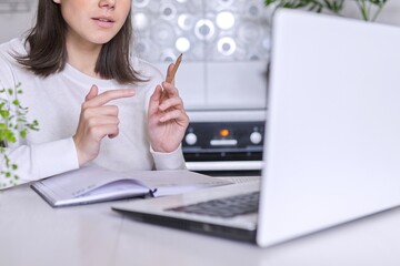 Woman teacher, mentor, psychologist looking at webcam of laptop