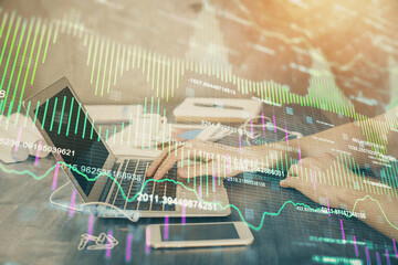 Double exposure of forex chart with man working on computer on background. Concept of market analysis.