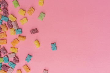 multi-colored jelly bears on a gently pink background
