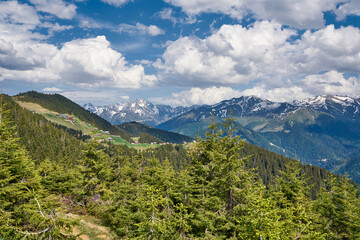 Landscape of Pokut Plateau with snowy mountains, clouds and green nature. Taken from Sal Plateau, Kackar Mountains, Rize, Black Sea / Karadeniz region of Turkey