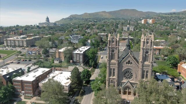 Aerial: Flying over Cathedral Of The Madeline in downtown Salt Lake City. Utah, USA
