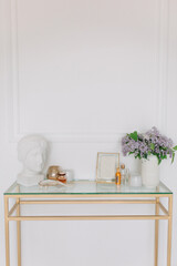 Girl’s makeup console near the white wall