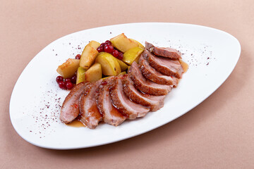 fried duck fillet with pear on a plate. close-up.