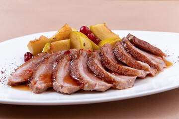 fried duck fillet with pear on a plate. close-up.