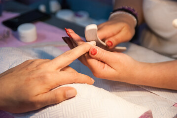 Obraz na płótnie Canvas Preparing nails with nail file for manicure