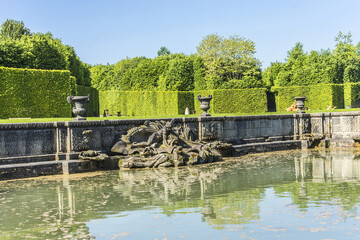 Neptune Fountain (1770) in gardens of famous Versailles palace. Palace of Versailles was a royal...