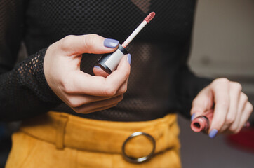 Open tube of liquid lipstick ready for applying