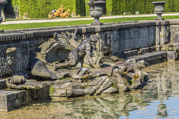 Neptune Fountain (1770) in gardens of famous Versailles palace. Palace of Versailles was a royal...