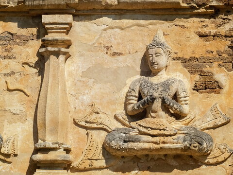 view of ancient buddha sculpture on brick wall of ruin temple, Wat Chet Yot or officially called Wat Photharam Maha Wihan in Chiang Mai City, northern of Thailand.