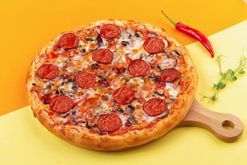 pepperoni pizza on a wooden plate. close-up.