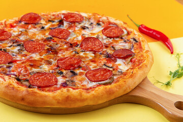 pepperoni pizza on a wooden plate. close-up.