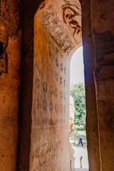 Decorated door of a buddhist pagoda. Buddhist images and deities painted on the wall. Vertical picture. Inn Thein, Inle lake region, Myanmar, Burma, southeast Asia