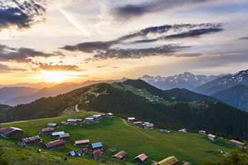 Sunrise landscape of Pokut and Sal Plateaus, with snowy mountains, clouds and green nature, Kackar Mountains, Rize, Black Sea / Karadeniz region of Turkey