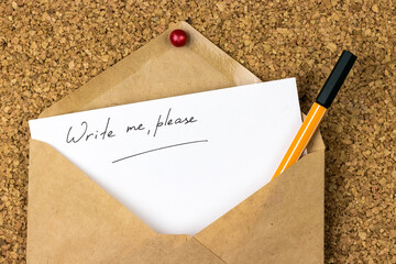 ?write me, please? - written by hand on a white sheet of paper, in a craft envelope with pen,...