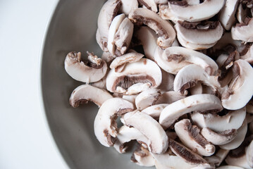Plate full of sliced white mushrooms