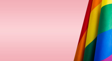 Pride community flags on pink background. Perfect banner, background for pride month. 