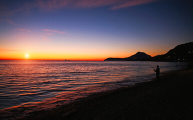 Spectacular romantic sunset on Mediterranean coast, clouds in colorful sky, Bar, Montenegro