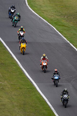 Multiple racing bikes cornering on a track