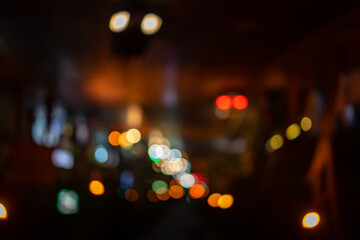 Abstract night bokeh from Thailand midnight street in dark and orange red tungsten mood and tone theme.