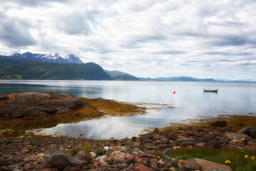 Norway. Landscape with fjord, boat and mountains on a summer day