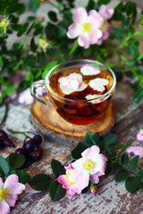 Obraz na płótnie Canvas Selective focus. Macro. Rosehip tea. Hot rosehip drink. Flowers and rose hips.