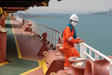 Fotobehang seaman covid-19 main deck and mooring equipment of cargo ship, vessel © Eugene