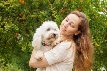 Beautiful young girl on a walk in the Park with her dog.